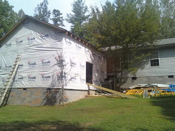 Tyvek wrapped gable on a new room addition beside an existing home in Finger